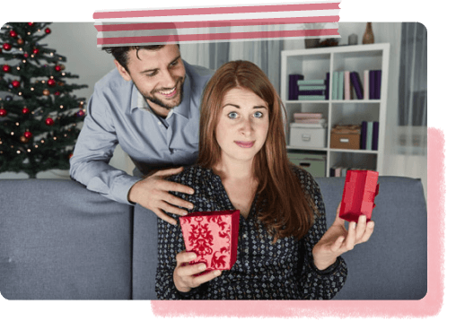 Woman opening gift but fakes delight