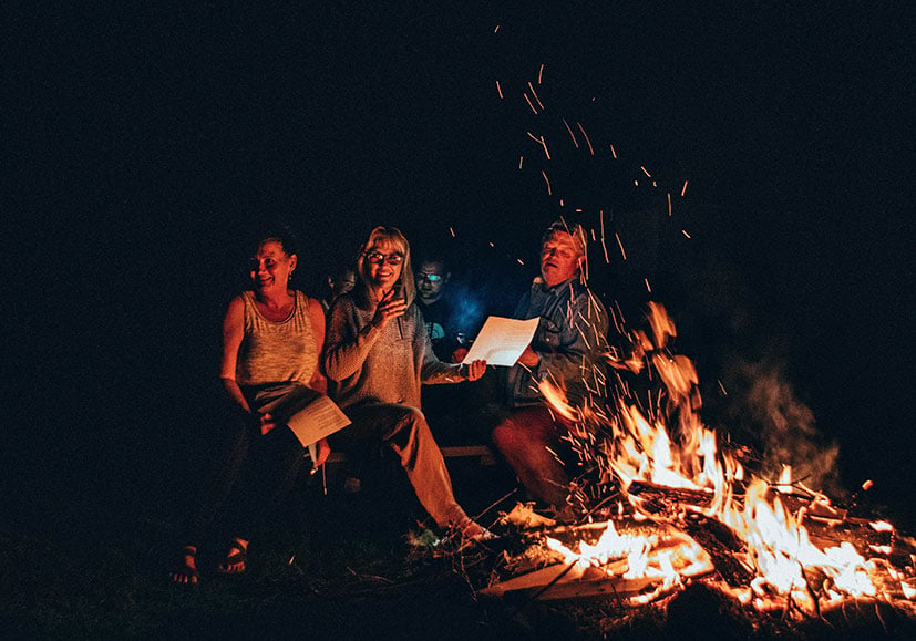 Family sitting around a bonfire