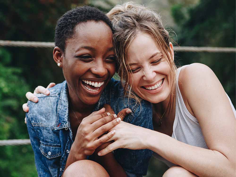 Two friends enjoying a joyful moment with each other.